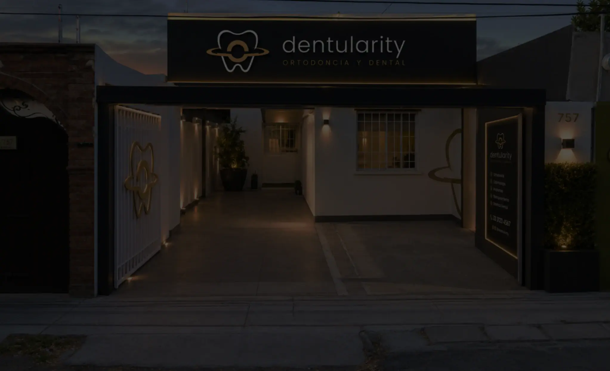 Fachada de la clínica Dentularity al anochecer